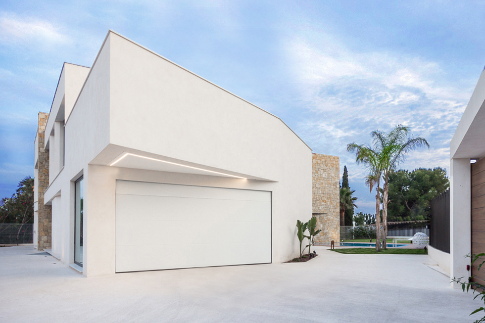 Garaje moderno con voladizo en blanco en vivienda de diseño Cumbres Chiralt Arquitectos Valencia