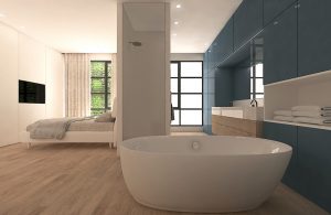 Baño azul en dormitorio con bañera exenta de estilo moderno